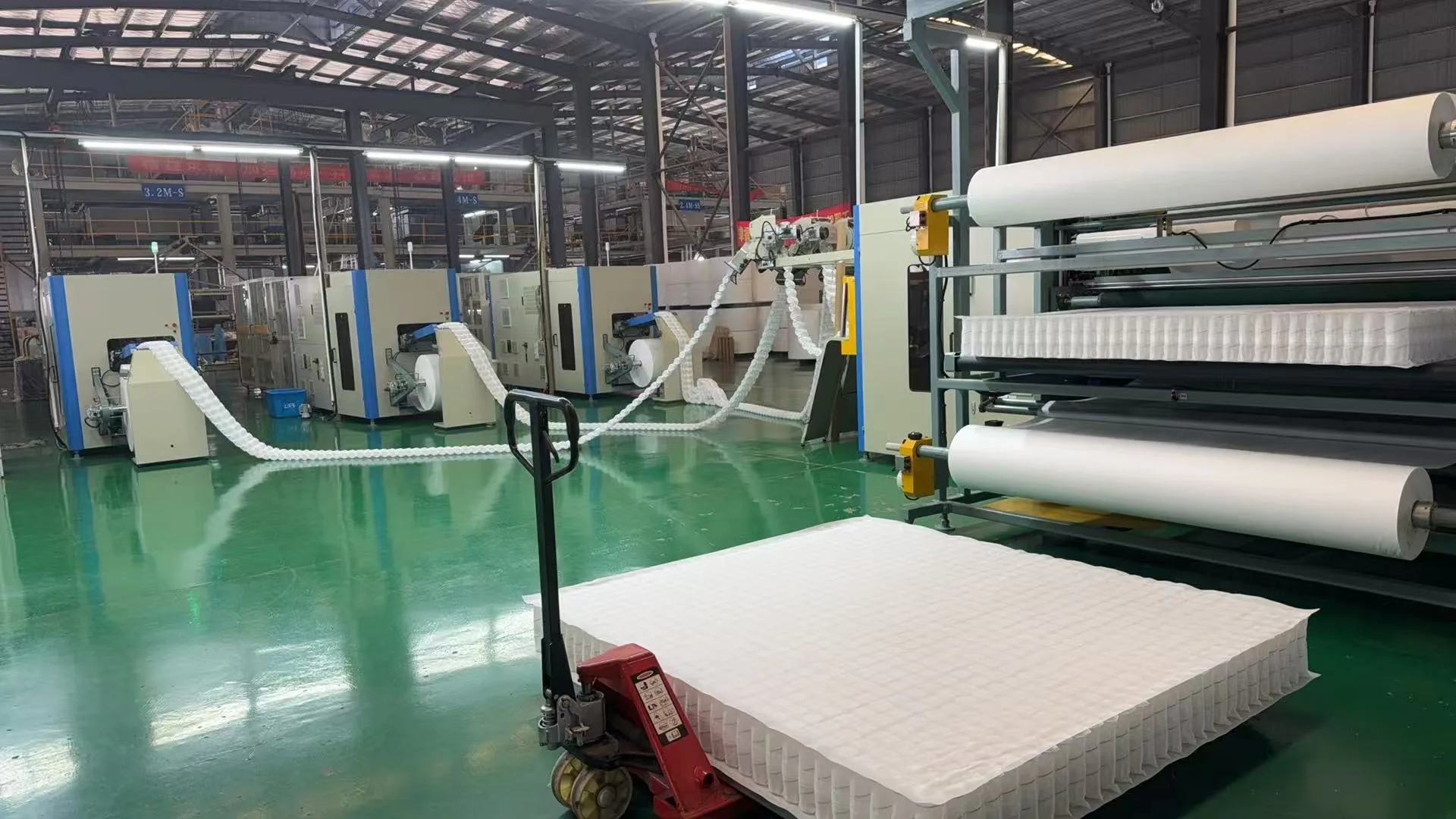 Greatech factory floor — pocket spring production line and completed spring unit