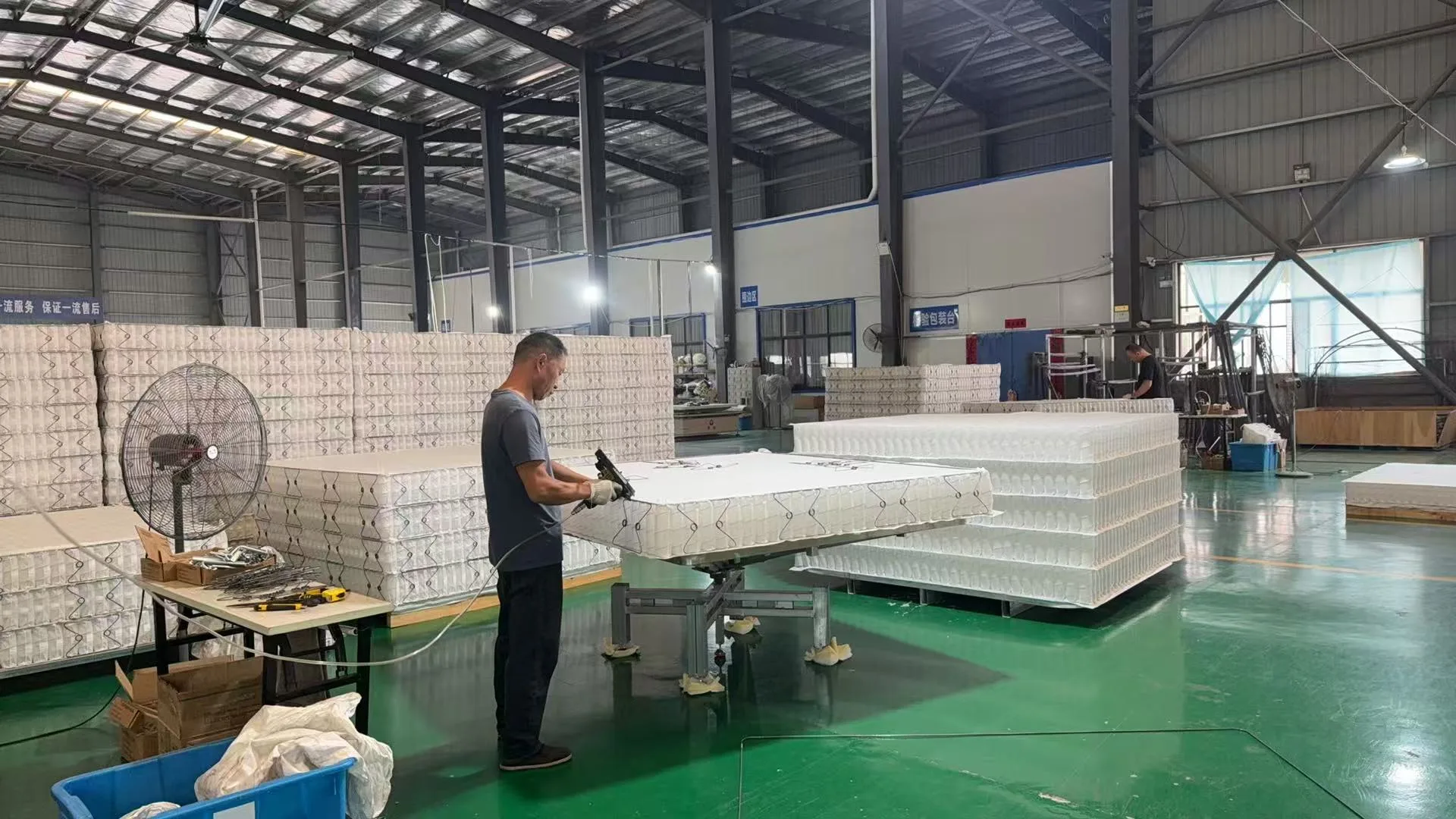 Mattress assembly — worker building pocket spring mattress in Greatech factory