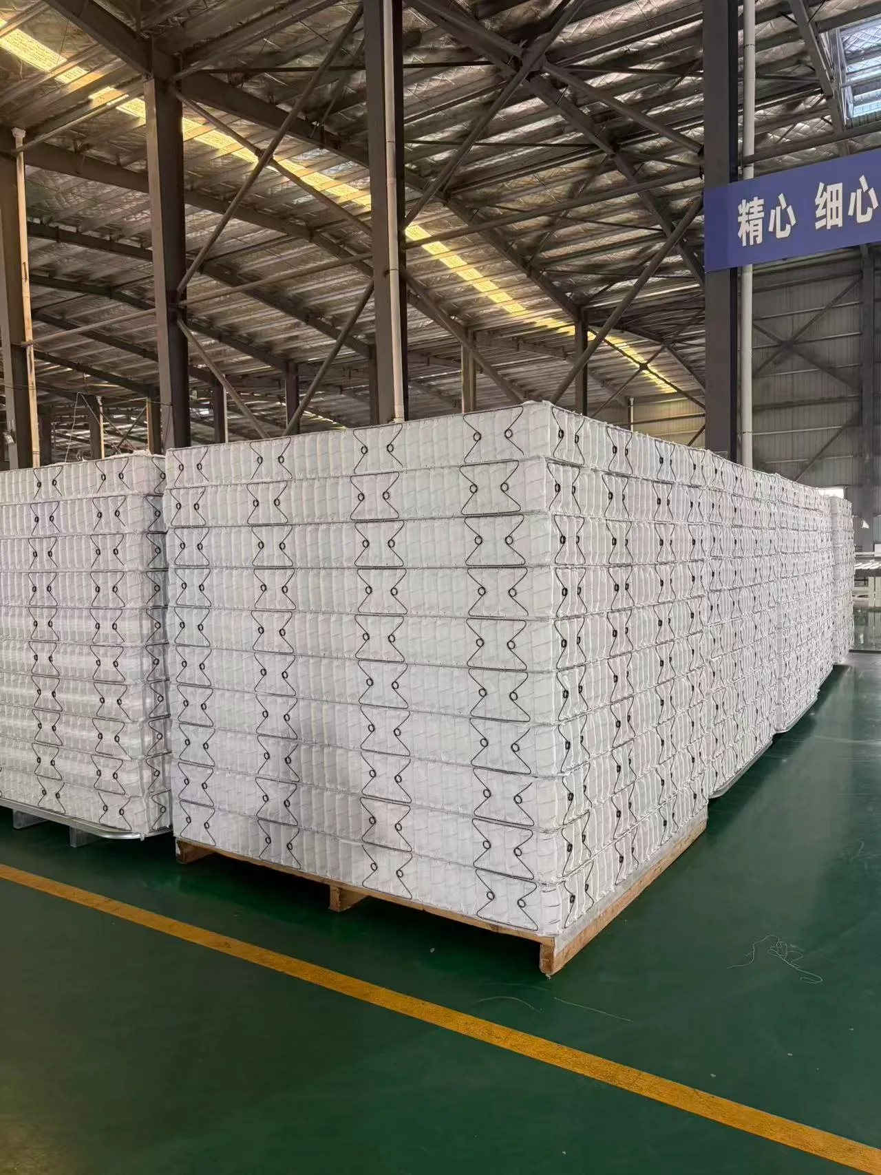 Pallets of completed nonwoven-wrapped pocket spring units — Greatech production
